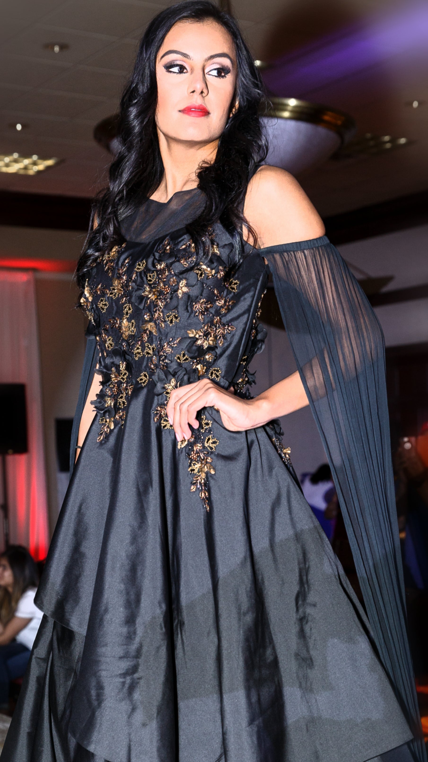 Womens silk black color gown with gold hand embroidery worn by a fashion model